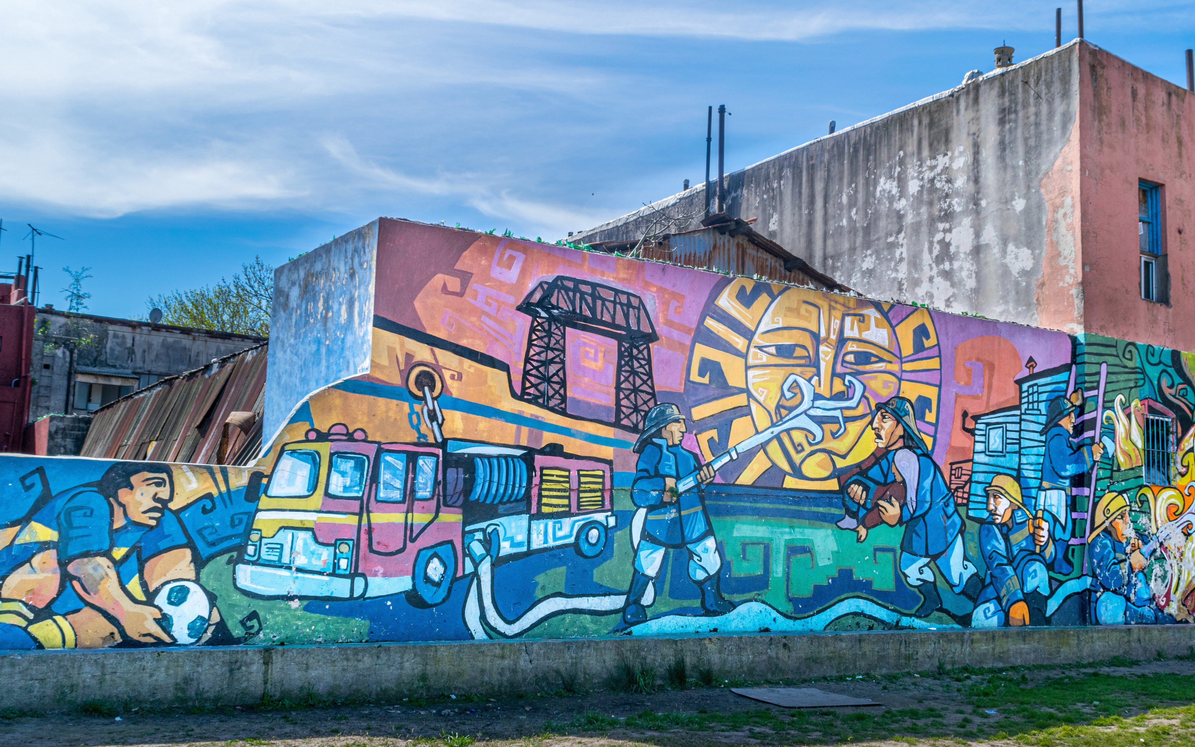 Colourful mural depicting local culture on a wall in La Boca, Buenos Aires walking tour.