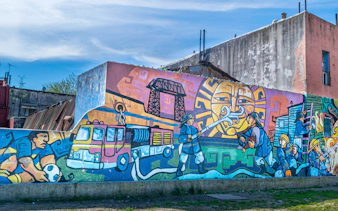 Colourful mural depicting local culture on a wall in La Boca, Buenos Aires walking tour.