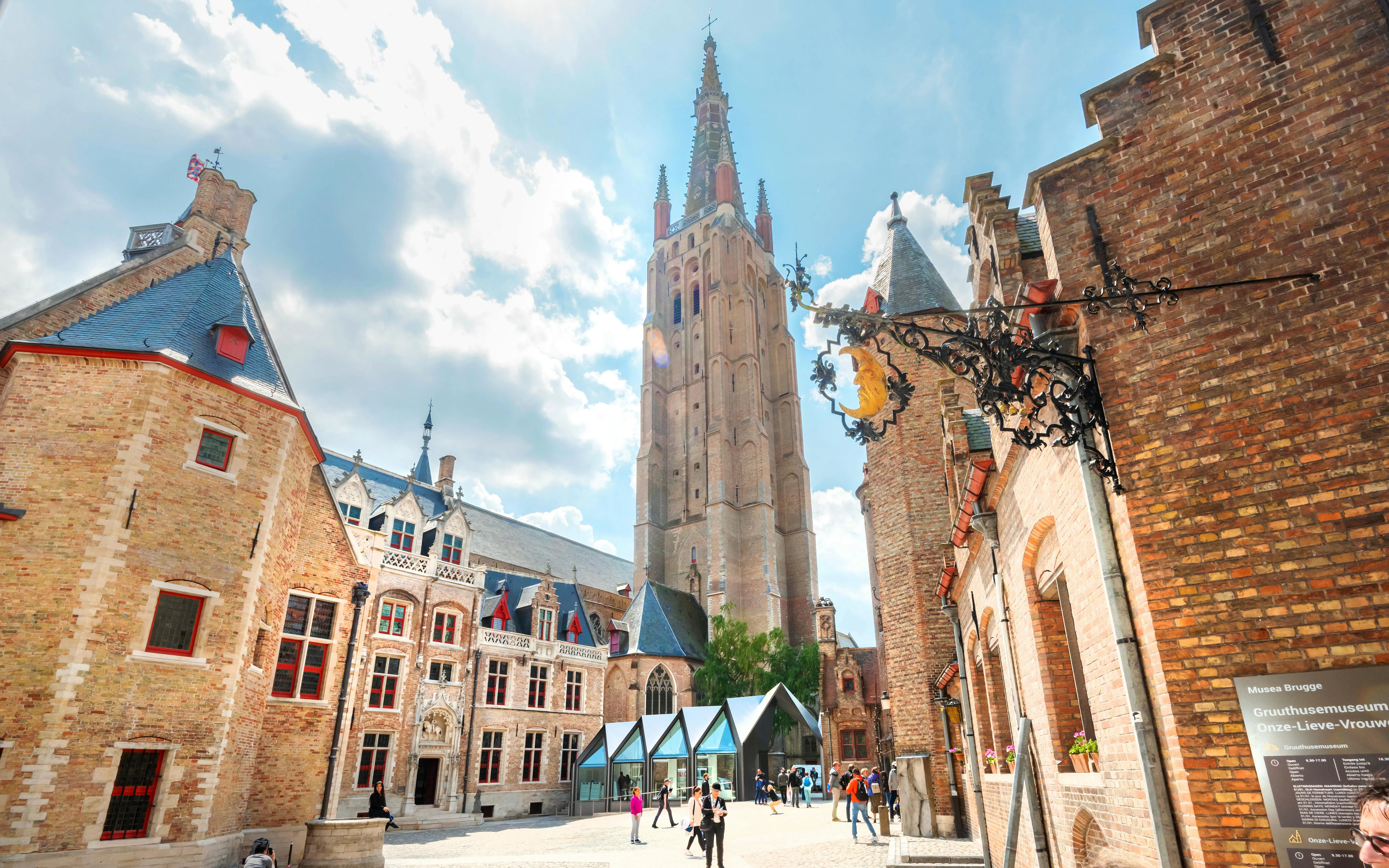 Gruuthusemuseum courtyard with Onze-Lieve-Vrouwekerk tower in Bruges, Belgium.