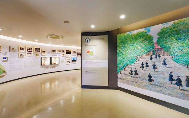 Exhibition hall with historical photos and a mural at Churaumi Aquarium, Okinawa.