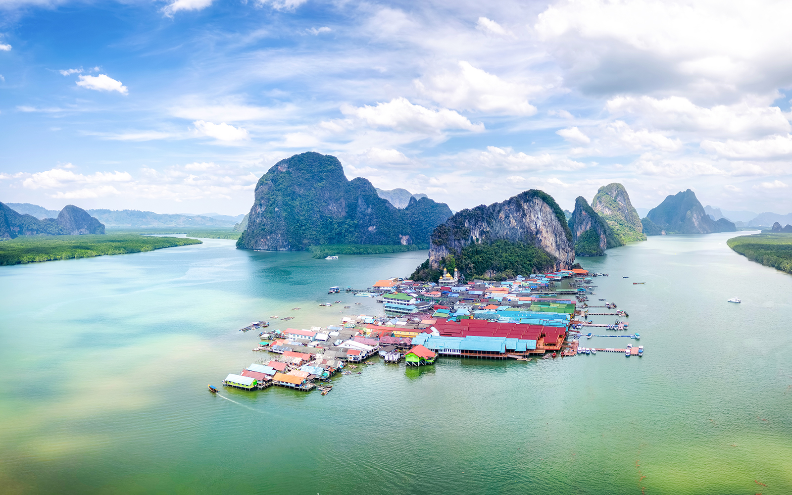 Panyee Island village and limestone cliffs in Phang Nga Bay, Thailand.