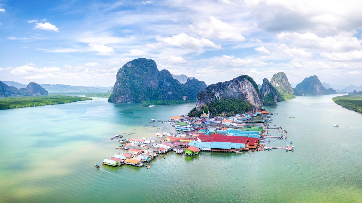 Panyee Island village and limestone cliffs in Phang Nga Bay, Thailand.
