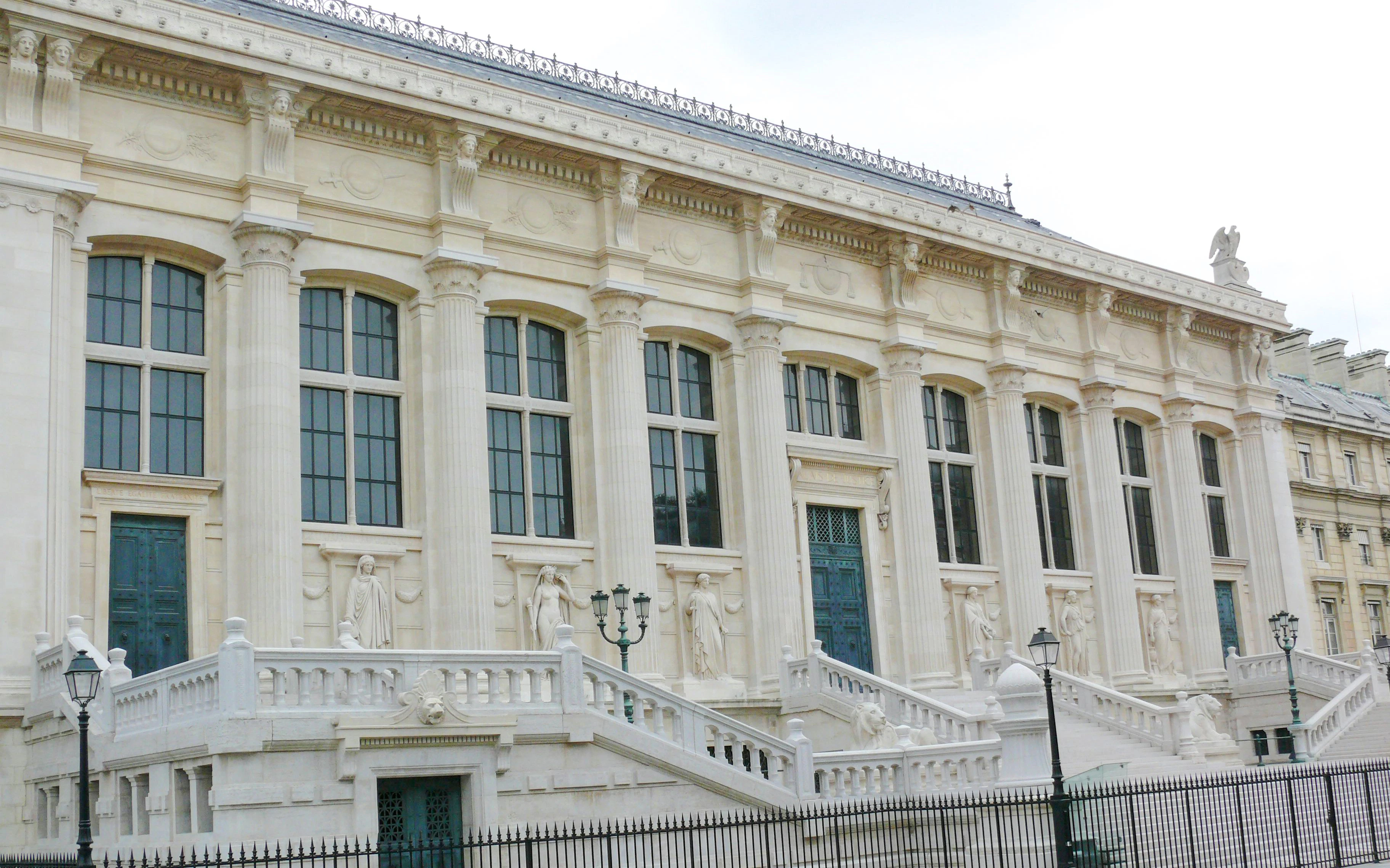 Elegant neoclassical building facade near Colonnes de Buren, Paris.