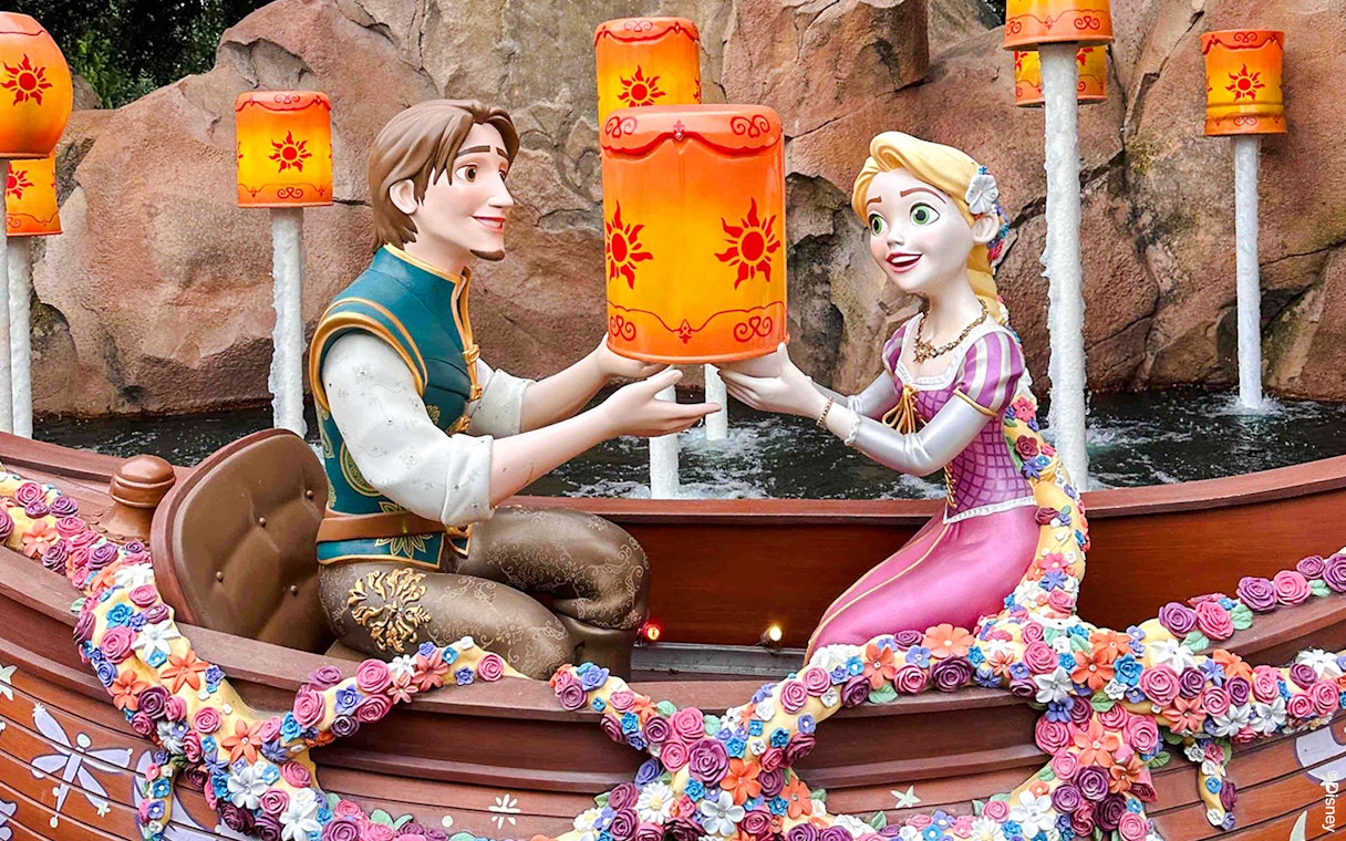 Characters in a boat holding lanterns during the Voyage to the Crystal Grotto.