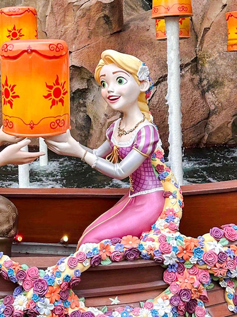 Characters in a boat holding lanterns during the Voyage to the Crystal Grotto.