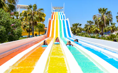 Visitors enjoying colorful water slides at Aquashow Park.