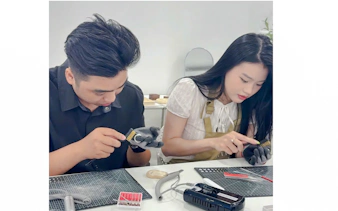 Participants crafting silver jewelry in a Da Nang workshop.