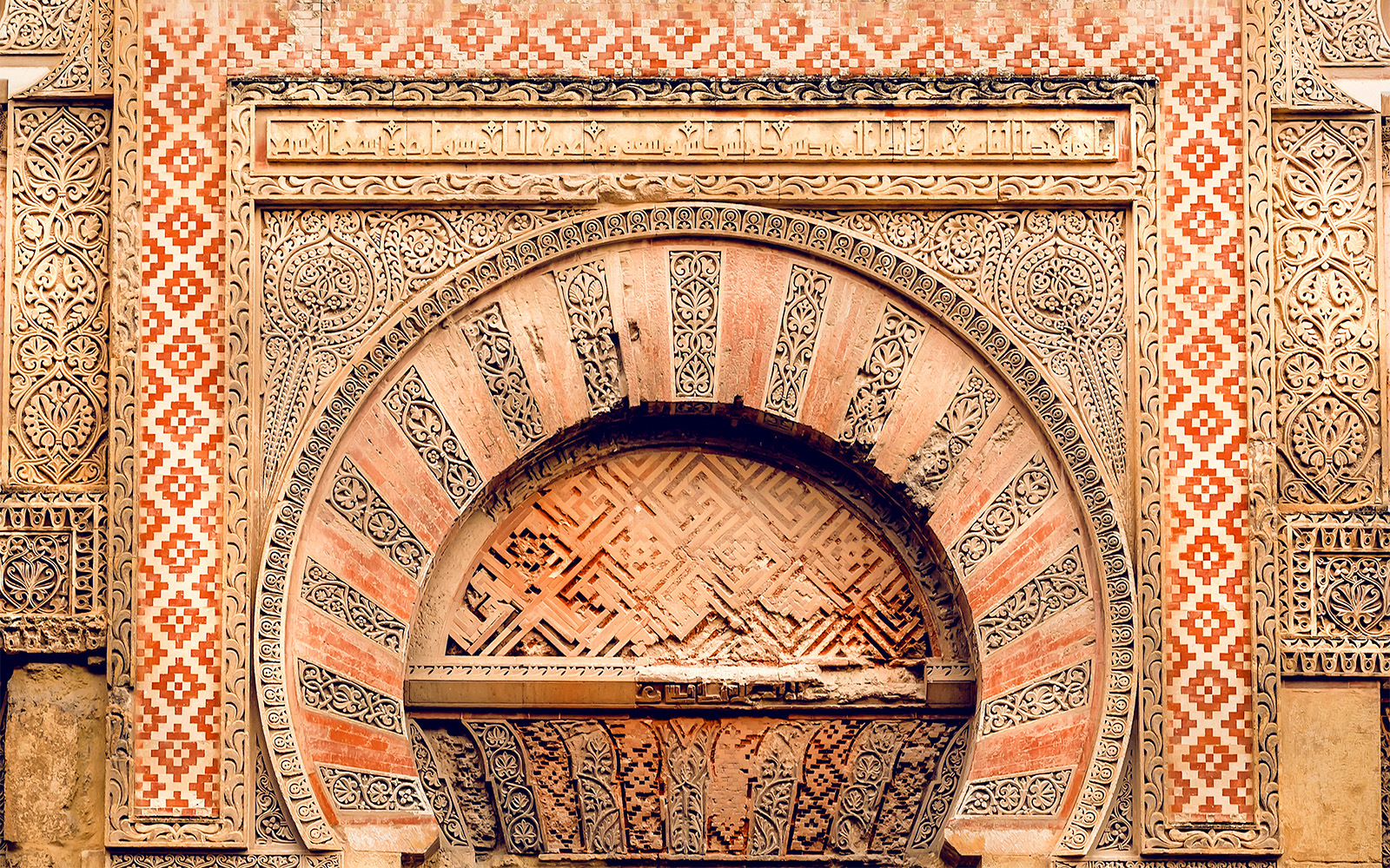Puerta de San Esteban arch detail at Mezquita Cordoba, featuring intricate geometric and floral patterns.