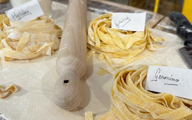 Fresh pasta dough with name tags at a cooking class in Rome.