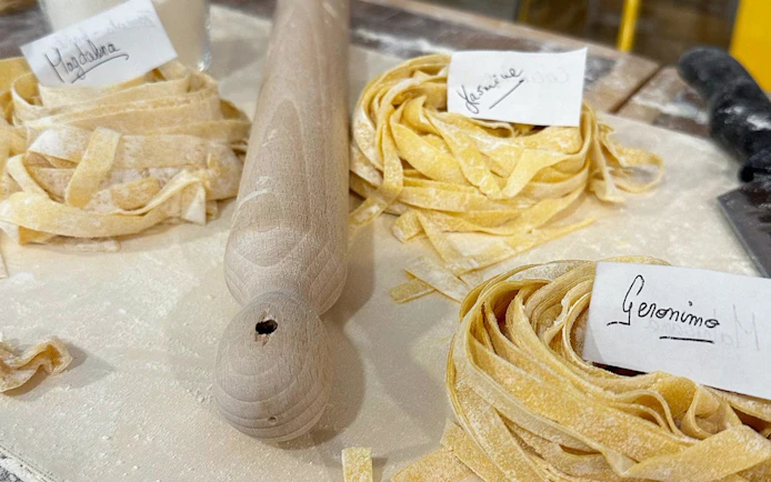 Fresh pasta dough with name tags at a cooking class in Rome.