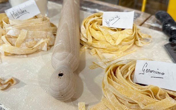 Fresh pasta dough with name tags at a cooking class in Rome.