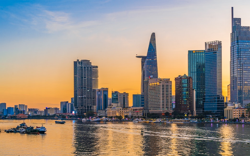Cityscape of Ho Chi Minh City with Bitexco Financial Tower at sunset.
