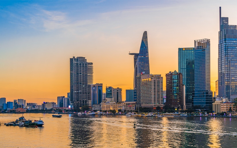 Cityscape of Ho Chi Minh City with Bitexco Financial Tower at sunset.