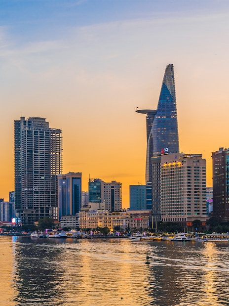 Cityscape of Ho Chi Minh City with Bitexco Financial Tower at sunset.