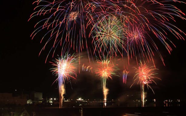Fireworks display over Otaru Canal during a night cruise in Japan.