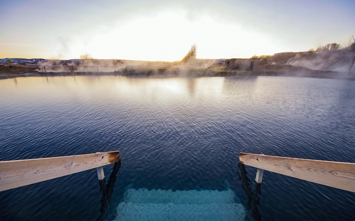 Stairs leading into the geothermal waters of Secret Lagoon, Gamla Laugin, Iceland.
