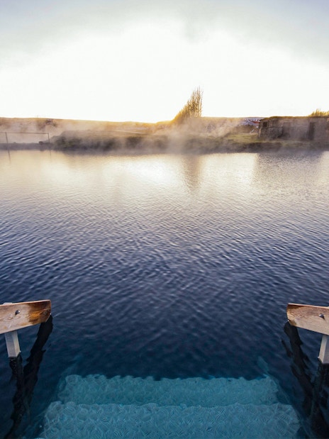 Stairs leading into the geothermal waters of Secret Lagoon, Gamla Laugin, Iceland.