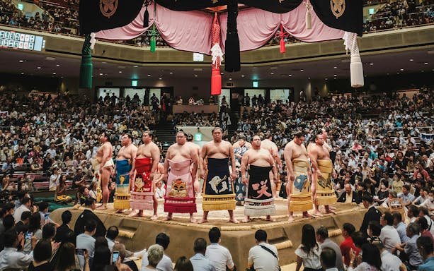 Sumo wrestlers line up in the ring at Tokyo Grand Sumo Tournament, Japan.