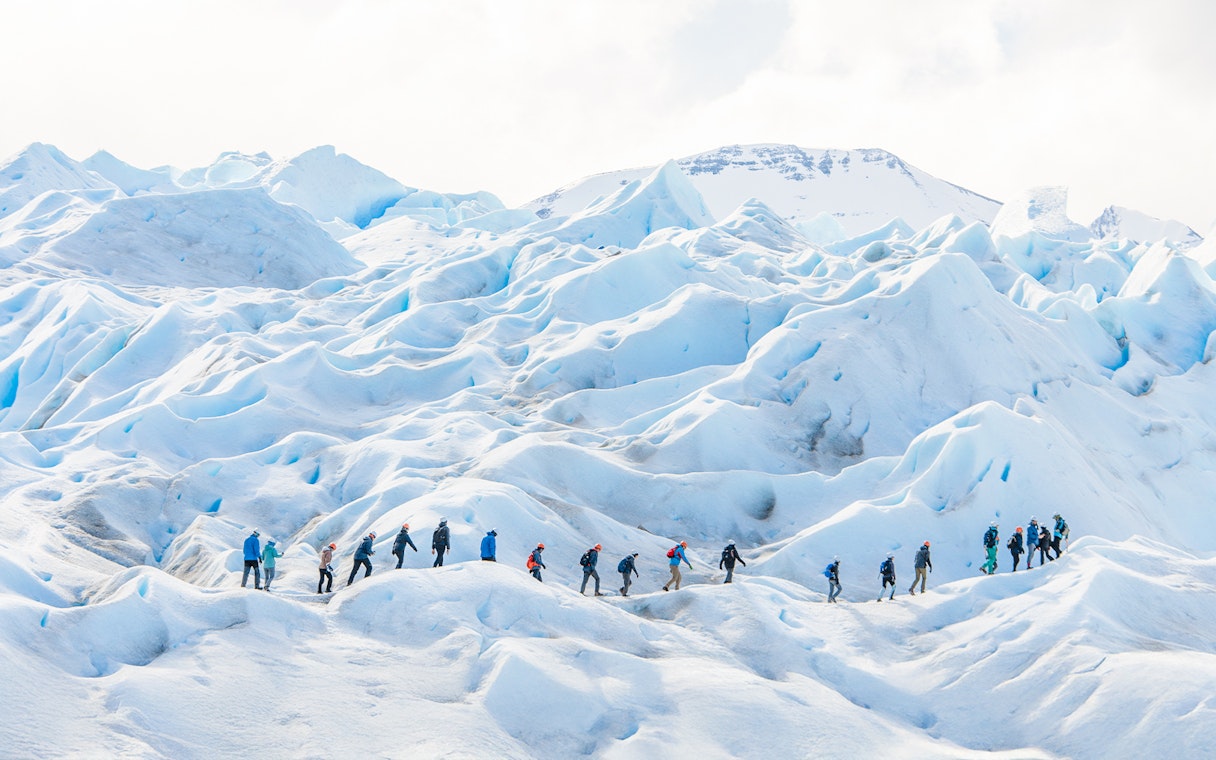 Tourists with guide hiking on Perito Moreno Glacier, Argentina.