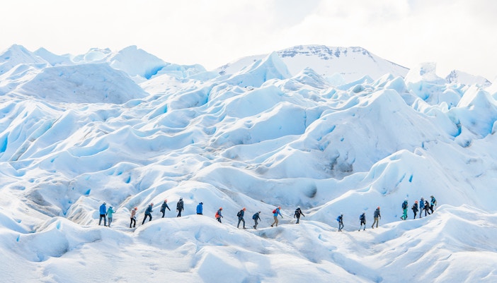 Tourists with guide hiking on Perito Moreno Glacier, Argentina.
