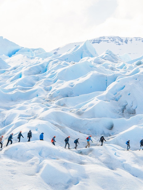 Tourists with guide hiking on Perito Moreno Glacier, Argentina.