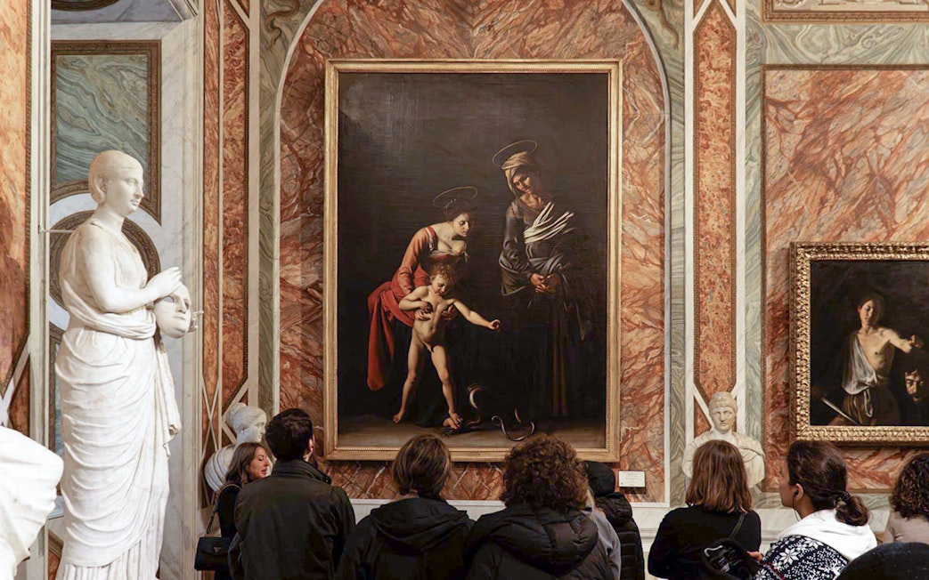Visitors viewing Caravaggio paintings in Borghese Gallery, Rome.