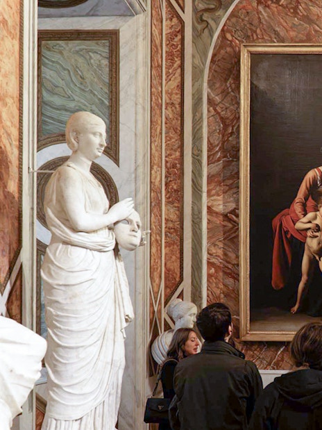 Visitors viewing Caravaggio paintings in Borghese Gallery, Rome.