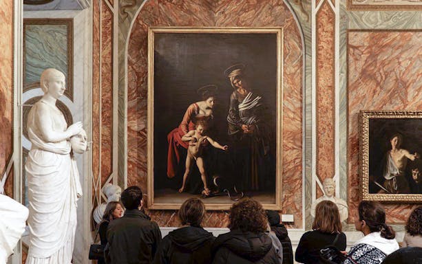 Borghese Gallery interior with classical paintings on ornate walls, Rome, Italy.