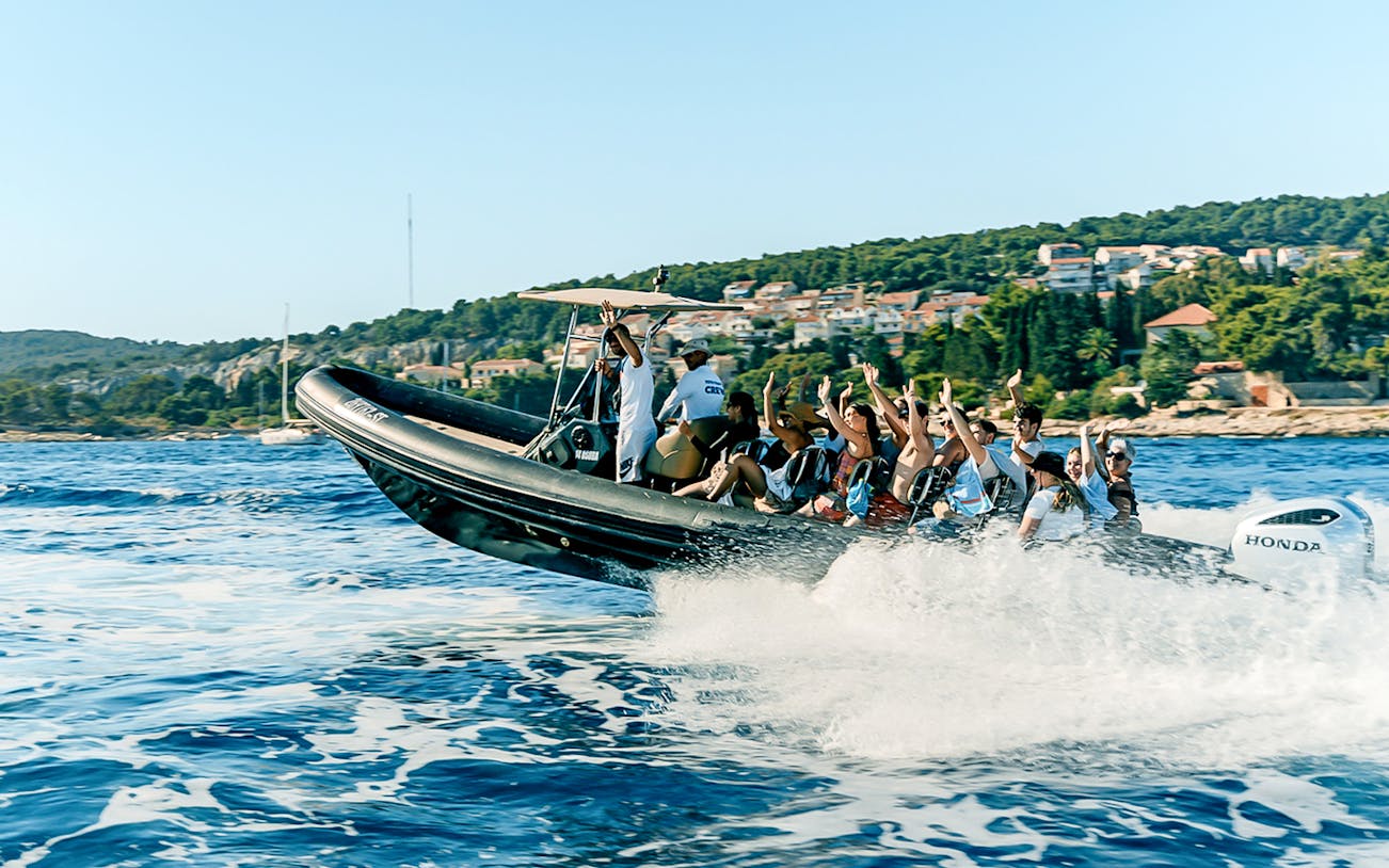 Guests on a speedboat tour in Dubai Marina with city skyline in the background