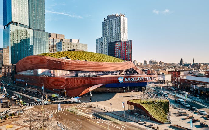 Barclays Center in Brooklyn, New York, with modern architecture and surrounding cityscape.
