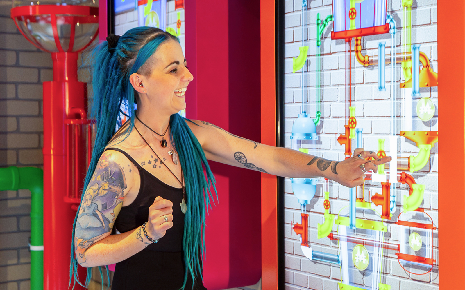 Person interacting with a Monopoly Dreams Melbourne exhibit touchscreen.