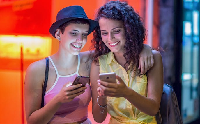 Girls using smartphones for Red Light District audio tour.