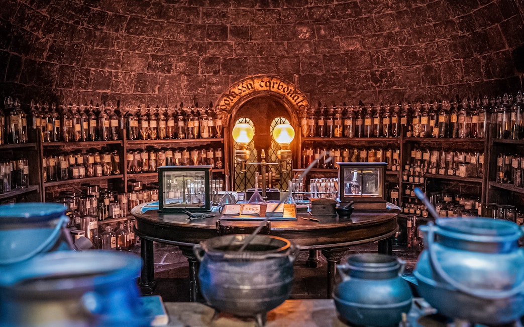 Potions classroom with cauldrons and shelves of bottles, Harry Potter London tour.