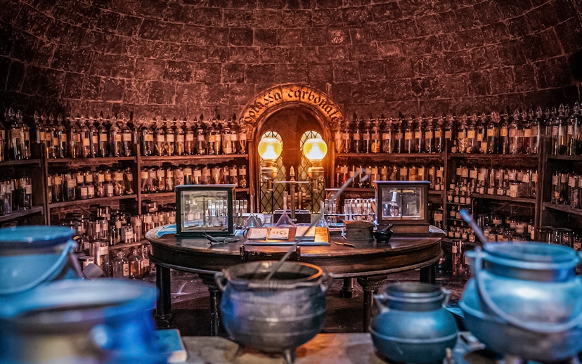 Potions classroom with cauldrons and shelves of bottles, Harry Potter London tour.