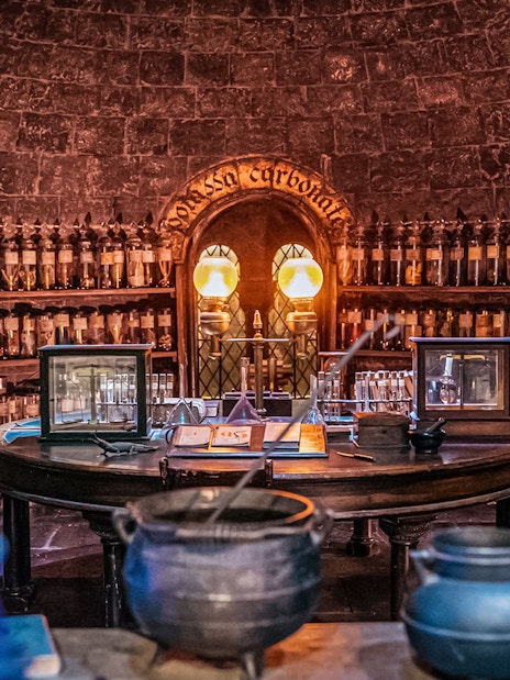 Potions classroom with cauldrons and shelves of bottles, Harry Potter London tour.