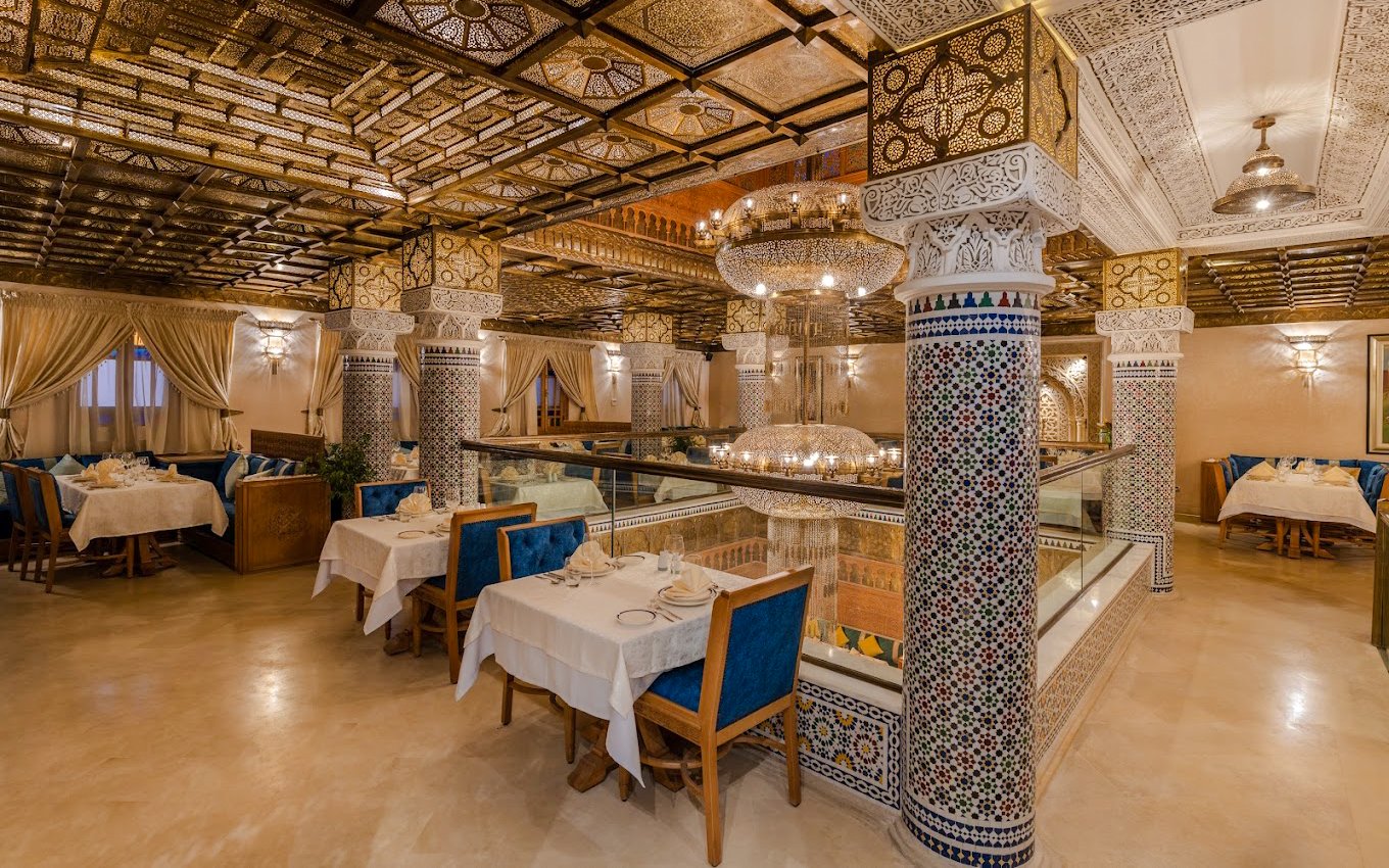 Elegant Moroccan restaurant interior with ornate columns and chandeliers in Casablanca, Morocco.