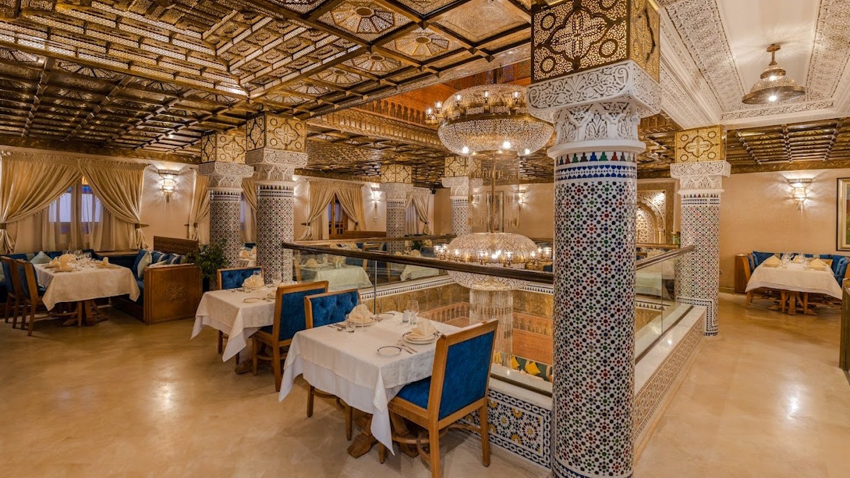 Elegant Moroccan restaurant interior with ornate columns and chandeliers in Casablanca, Morocco.