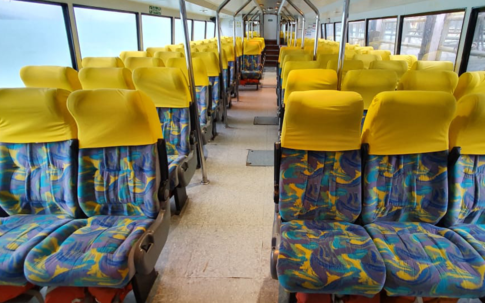 Cruz del Sur boat interior with yellow and blue patterned seats, Argentina.