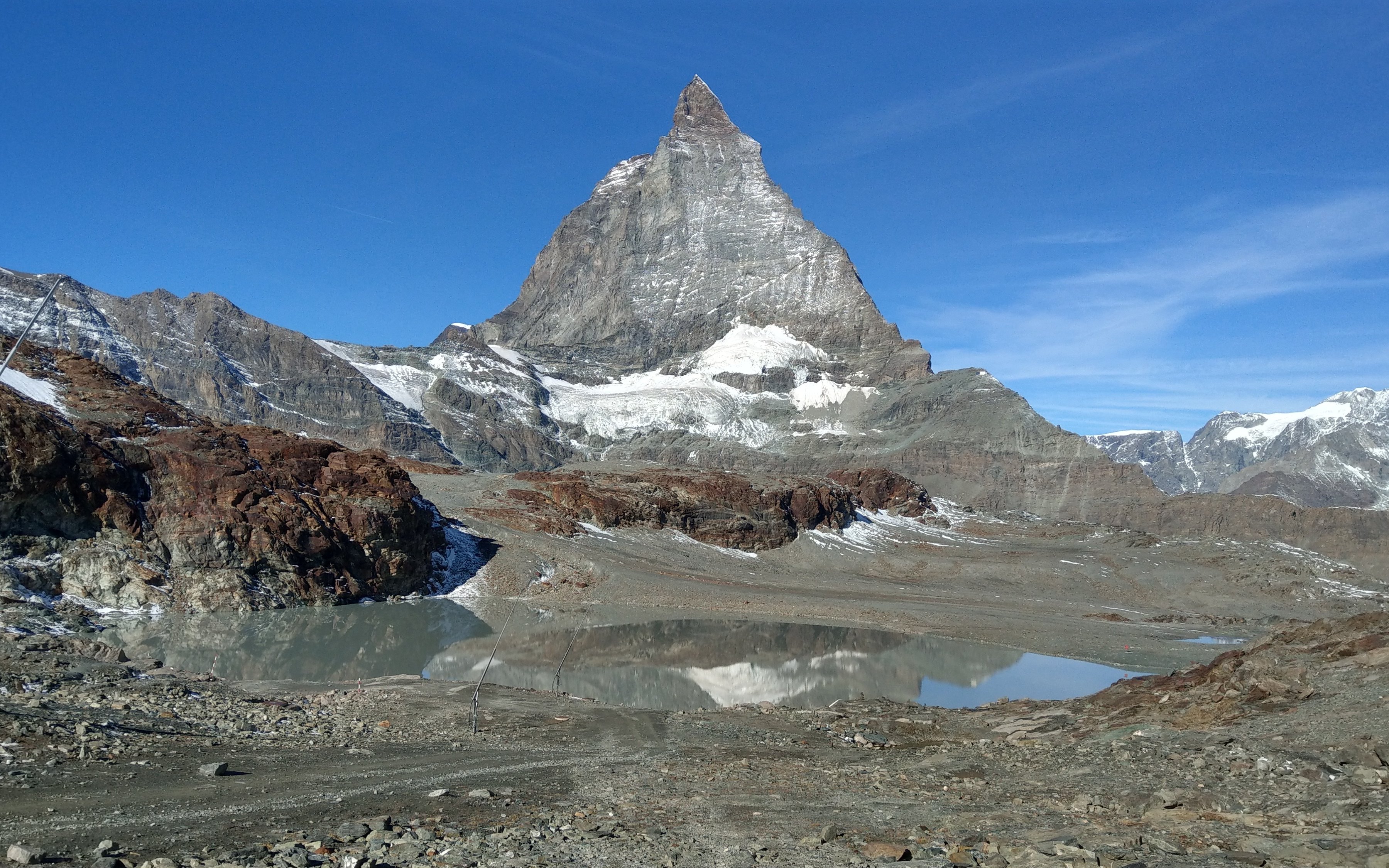 Trockener Steg view of the Matterhorn with rocky terrain and a small lake.