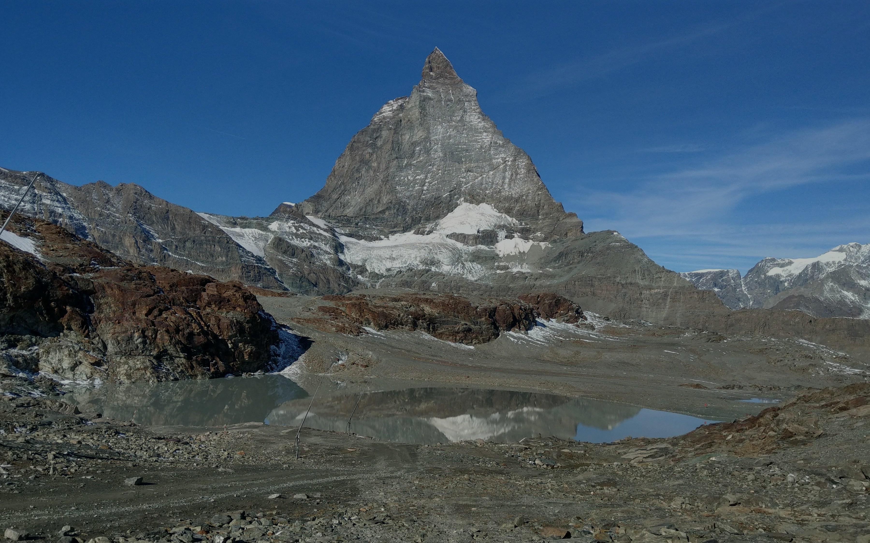 Trockener Steg view of the Matterhorn with rocky terrain and a small lake.