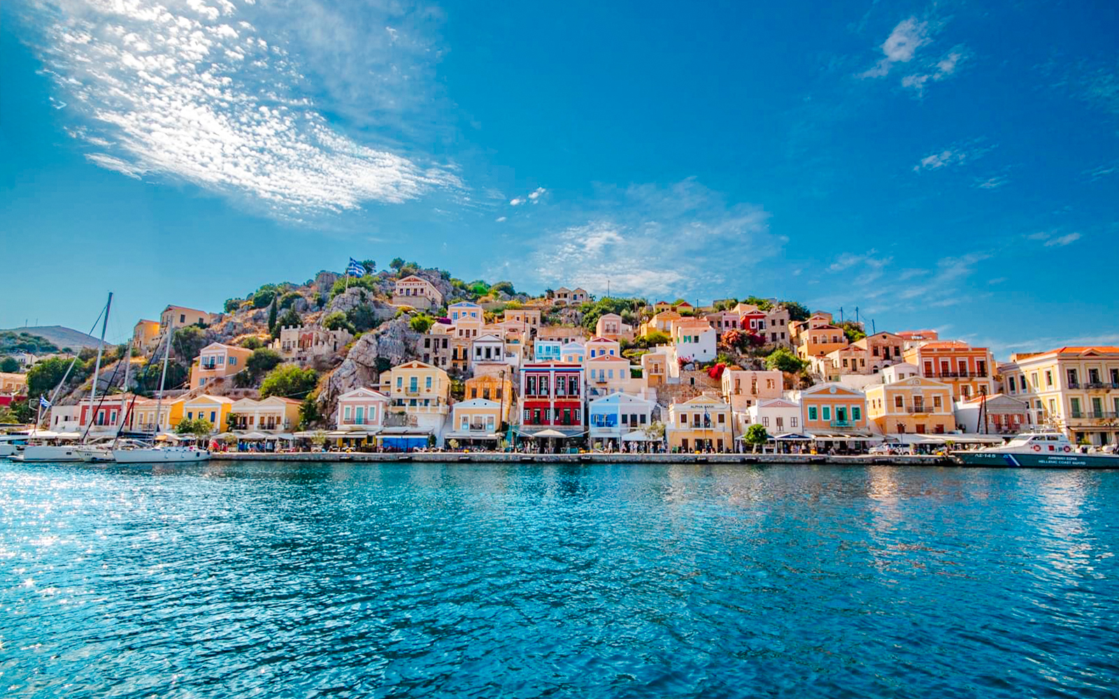 Colorful houses along the waterfront in Symi, Rhodes, Greece.