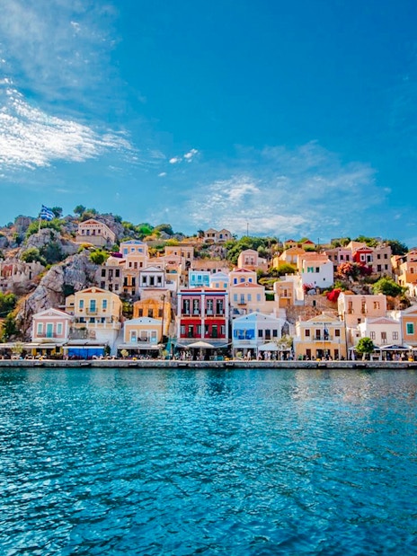 Colorful houses along the waterfront in Symi, Rhodes, Greece.
