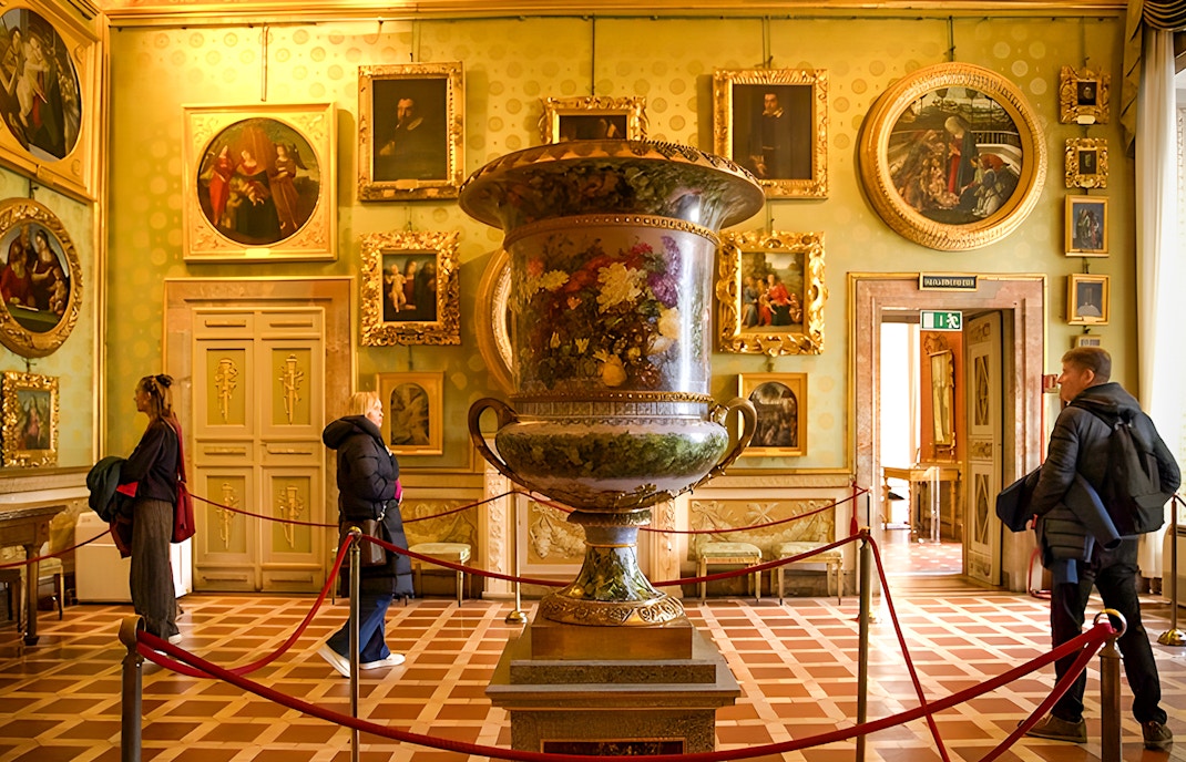 Palazzo Pitti facade in Florence with tourists entering through skip-the-line access.