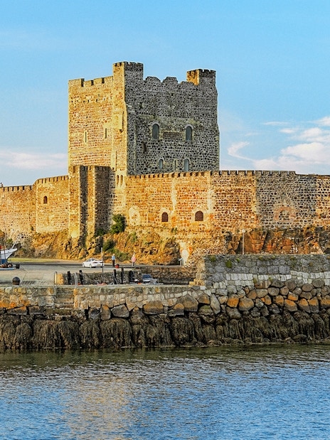 Carrickfergus Castle by the water, featured in Game of Thrones location tour.