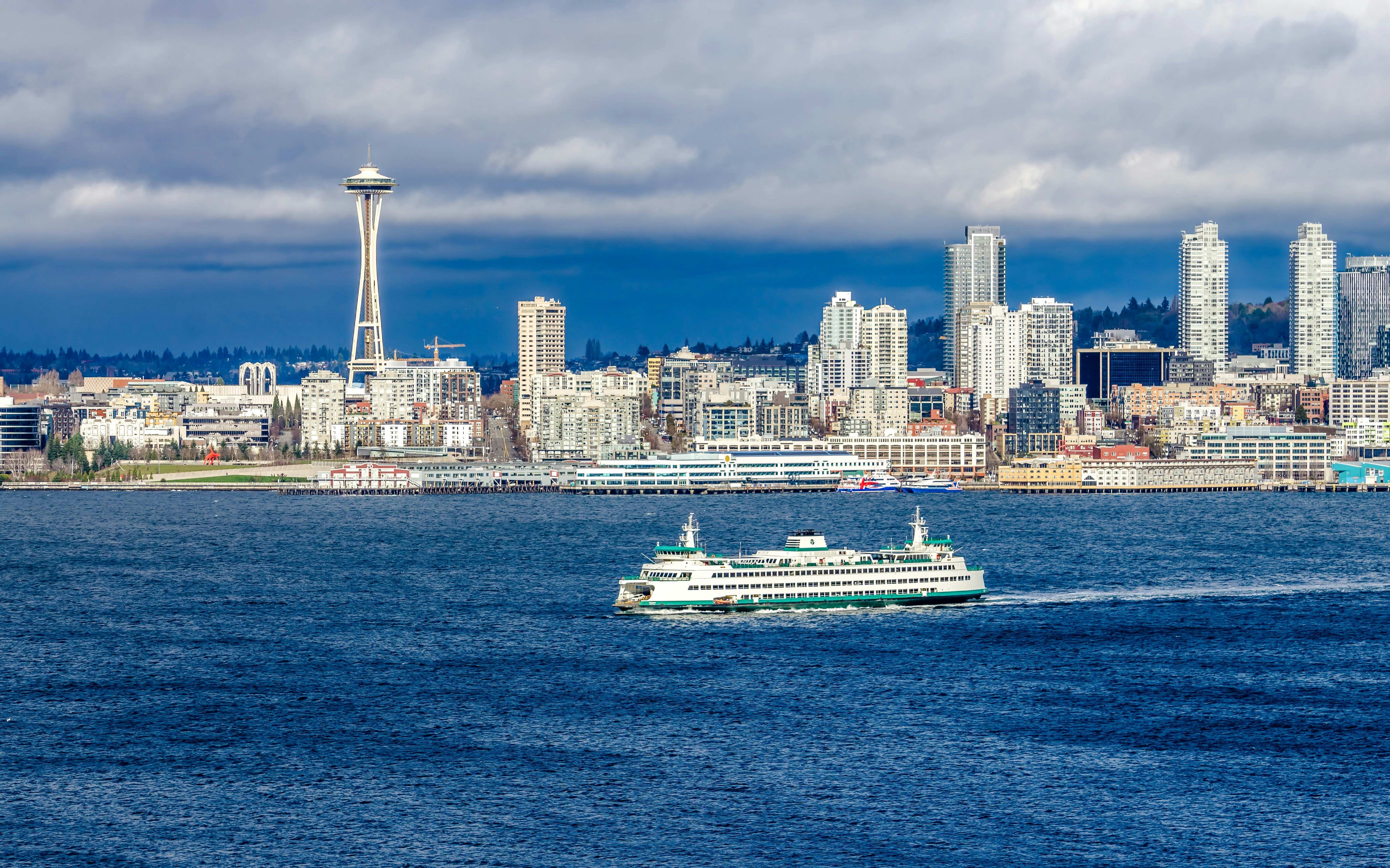 Seattle ferry crossing with skyline and Space Needle in the background.