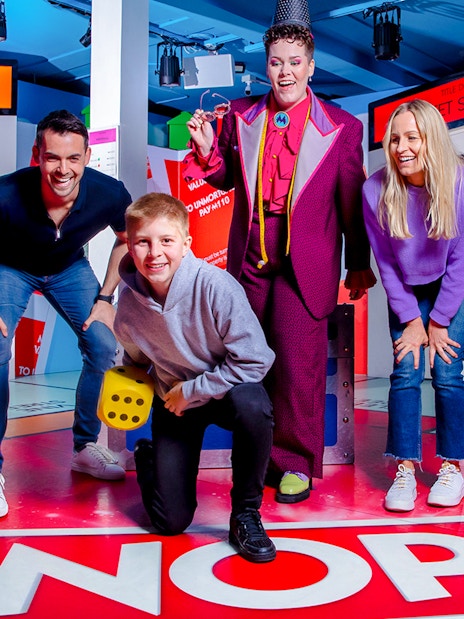 Guests enjoying the Monopoly Lifesized experience in London with a large dice and themed set.