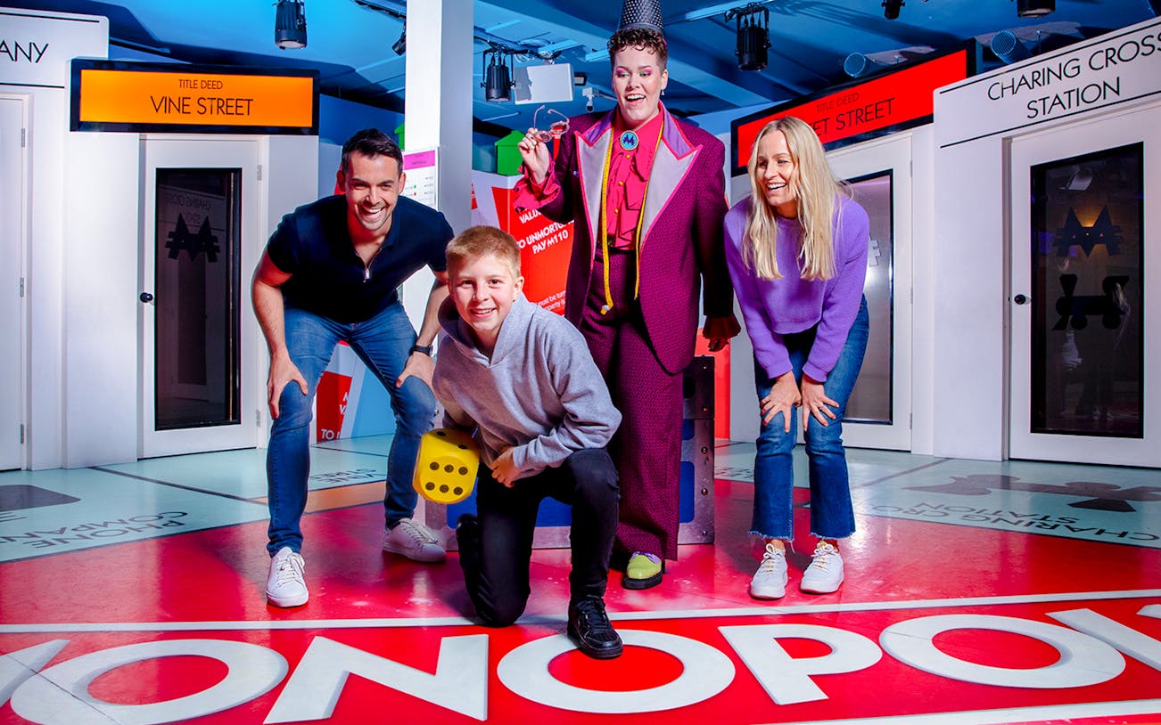 Guests playing a life-sized Monopoly game at Monopoly Lifesized experience in London.