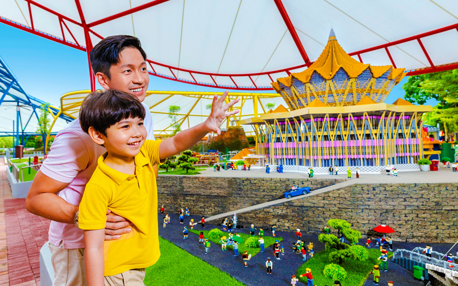 Father and son enjoying a miniature display at Legoland Malaysia theme park.
