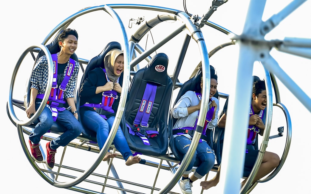 People enjoying the Slingshot ride in Singapore, experiencing thrill and excitement.