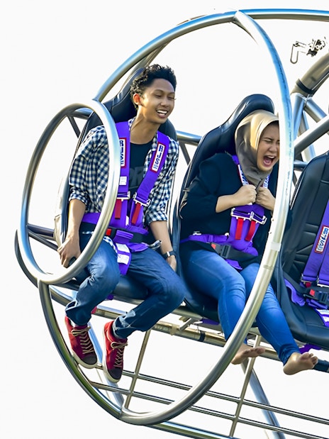People enjoying the Slingshot ride in Singapore, experiencing thrill and excitement.